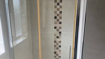 Shower, towels, soap, toilet paper