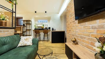 Deluxe Studio Suite | Living area | Flat-screen TV