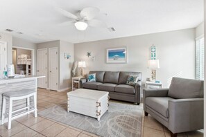 Relax in a comfortable seating area with a sofa, armchair, and coffee table.
