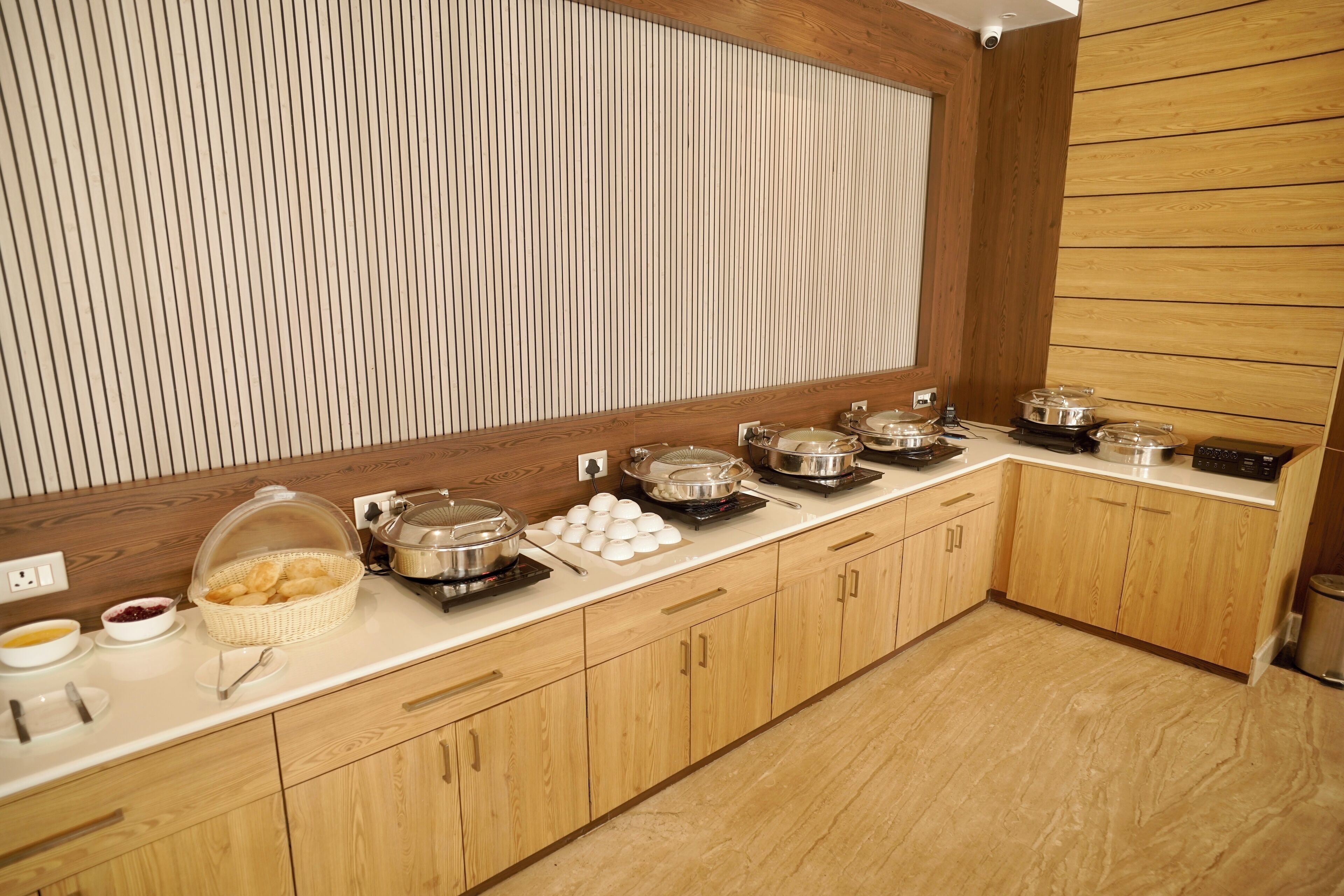 A buffet setup with various food items and serving utensils.