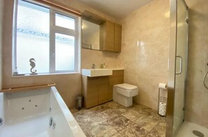 Shower, jetted tub, towels, soap