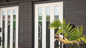 A building facade with two doors labeled "Apartment Two" and "Apartment Three". - The Residence Apartment Two (New Plymouth)