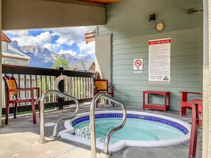Outdoor spa tub - Pines & Peaks  - 2 Bedroom Mountain View Condo with Pool & Hot Tubs (Canmore)