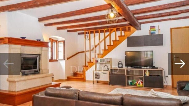 A spacious living room with a fireplace, a sofa, a television, and a staircase. - Villa Adriana - Two Bedroom Villa (Bale)