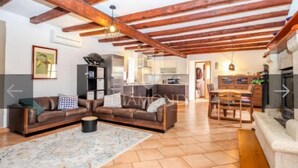 A spacious living area with exposed wooden beams, a sofa set, a coffee table, and a fireplace. - Villa Adriana - Two Bedroom Villa (Bale)