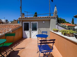 Enjoy dining or socializing in this outdoor space with a table and chair.