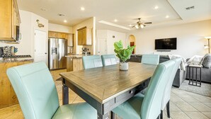A spacious kitchen with a dining area, a living room, and a TV. - Home w/ Game Room: Near Zion National Park! (Hurricane)