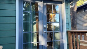 A front door with a glass panel, a keypad lock, and a small mailbox.