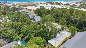 An aerial view of a coastal residential area with houses, dense greenery, and a beach. - As You Like It by Avantstay Steps to Beach, Bikes, Sleeps 18! (Santa Rosa Beach)