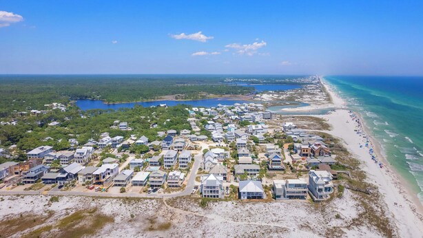 An aerial view of a coastal residential area with houses, a beach, and a clear blue sky. - As You Like It by Avantstay Steps to Beach, Bikes, Sleeps 18! (Santa Rosa Beach)