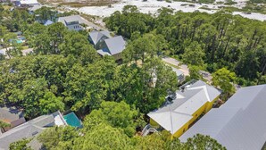 An aerial view of a residential area with houses, dense greenery, and a beach. - As You Like It by Avantstay Steps to Beach, Bikes, Sleeps 18! (Santa Rosa Beach)