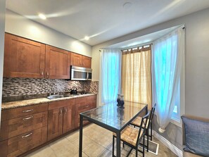 Fridge, microwave, stovetop, coffee/tea maker