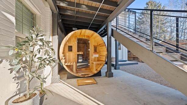 A wooden sauna structure with a door, a concrete ramp, and potted plants. - Walkable Downtown Spa Retreat (Bend)
