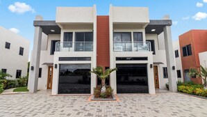 A modern building with two floors, large windows, and a central entrance. - Coastal Escape Tower Isle Beach Nearby (Tower Isle)