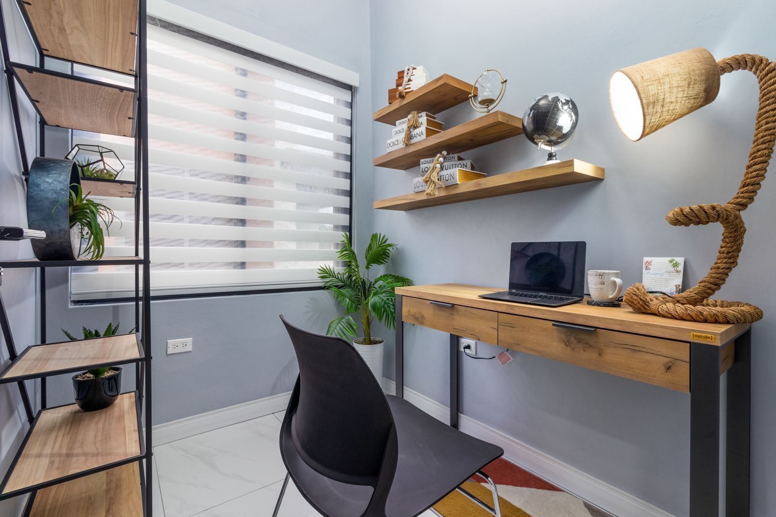A modern office space with a desk, chair, shelves, and decorative items.