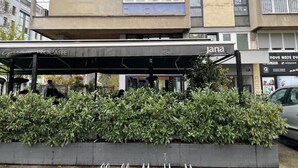 A building with a covered outdoor seating area, a sign for 'Greenery ProCaffe', and a 'jana' sign. - Charming Apartment in Nature (Zagreb)
