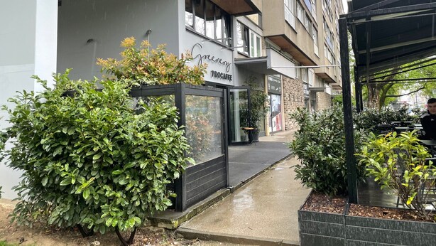 A modern building with a green sign for a coffee shop. - Charming Apartment in Nature (Zagreb)
