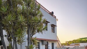 A two-story building with a white facade, a red roof, and a balcony. - Apartment Padres A for 4 People (La Orotava)