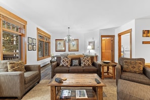 A cozy living room with a brown sofa set, a wooden coffee table, and framed artwork on the walls. - Le3012-2 (Keystone)