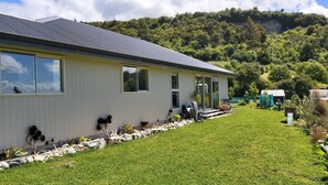 A modern building with a metal roof, large windows, and a well-maintained lawn. - Ruru at Ligar Bay (Ligar Bay)