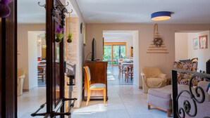 A spacious living area with a dining table, a sofa, and a TV. - Villa Benka With View (Tinjan)