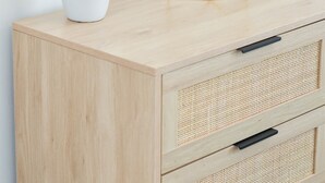 A wooden cabinet with a white vase containing dried plants, a geometric gold vase, and two white vases with circular handles. - Boho Studio Downtown Amish Country + Scenic Views (Walnut Creek)