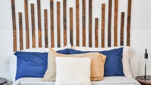 A bed with blue and white bedding, a white textured pillow, and a wooden headboard. - Luxury Honeymoon Suite Amazing Views Amish Country (Walnut Creek)