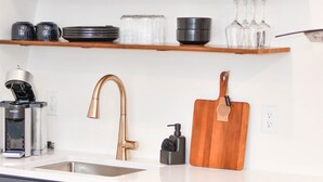A modern kitchen with a white countertop, dark blue cabinets, and a stainless steel oven. - Luxury Honeymoon Suite Amazing Views Amish Country (Walnut Creek)