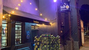 A restaurant named 'hak' with outdoor seating, a signboard, and string lights. - Casa Fortel, Centro Internacional (Bogotá)