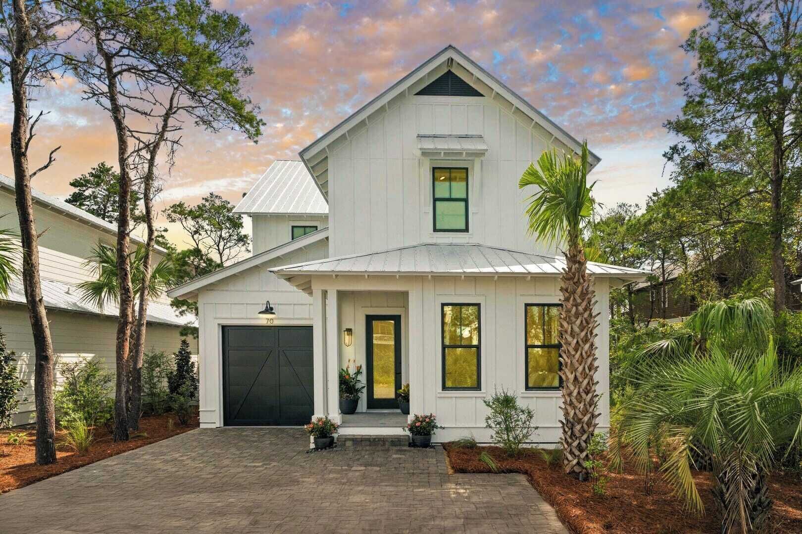 A two-story house with a garage, a front porch, and a driveway.