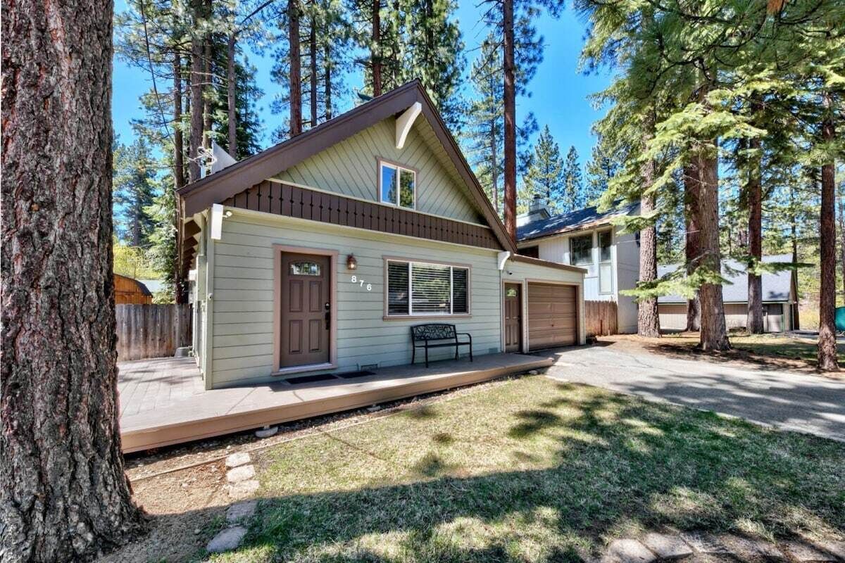 Front deck with a bench beside the entry door.