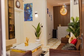Welcome to our lobby, featuring a reception desk, comfortable seating area, and a stylish coffee table.