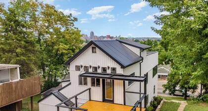 Downtown skyline view featuring giant rooftop deck & wet bar with a city view.