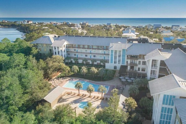 A resort with a pool, multiple buildings, and a view of the ocean. - Hello 30a! by Avantstay Private Beach Access + Shared Pool (Santa Rosa Beach)