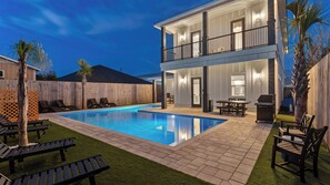 A two-story house with a swimming pool, outdoor seating, and a barbecue area. - Wanderlust by Avantstay Walk to Beach + Pool New Construction (Panama City Beach)