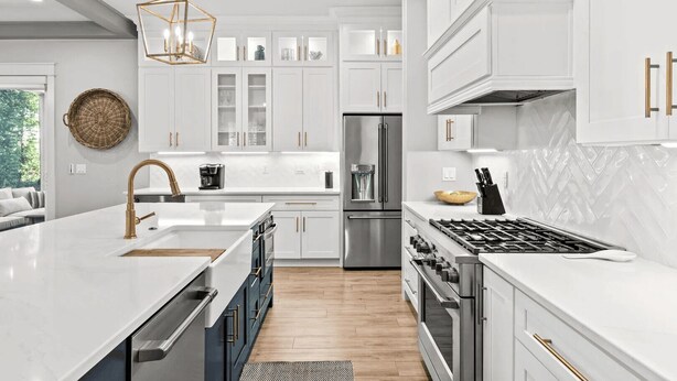 A modern kitchen with white cabinetry, stainless steel appliances, and a central island. - Cabana Blue by Avantstay Walk to Beach, Golf Cart+bikes Included Pool Access (Santa Rosa Beach)