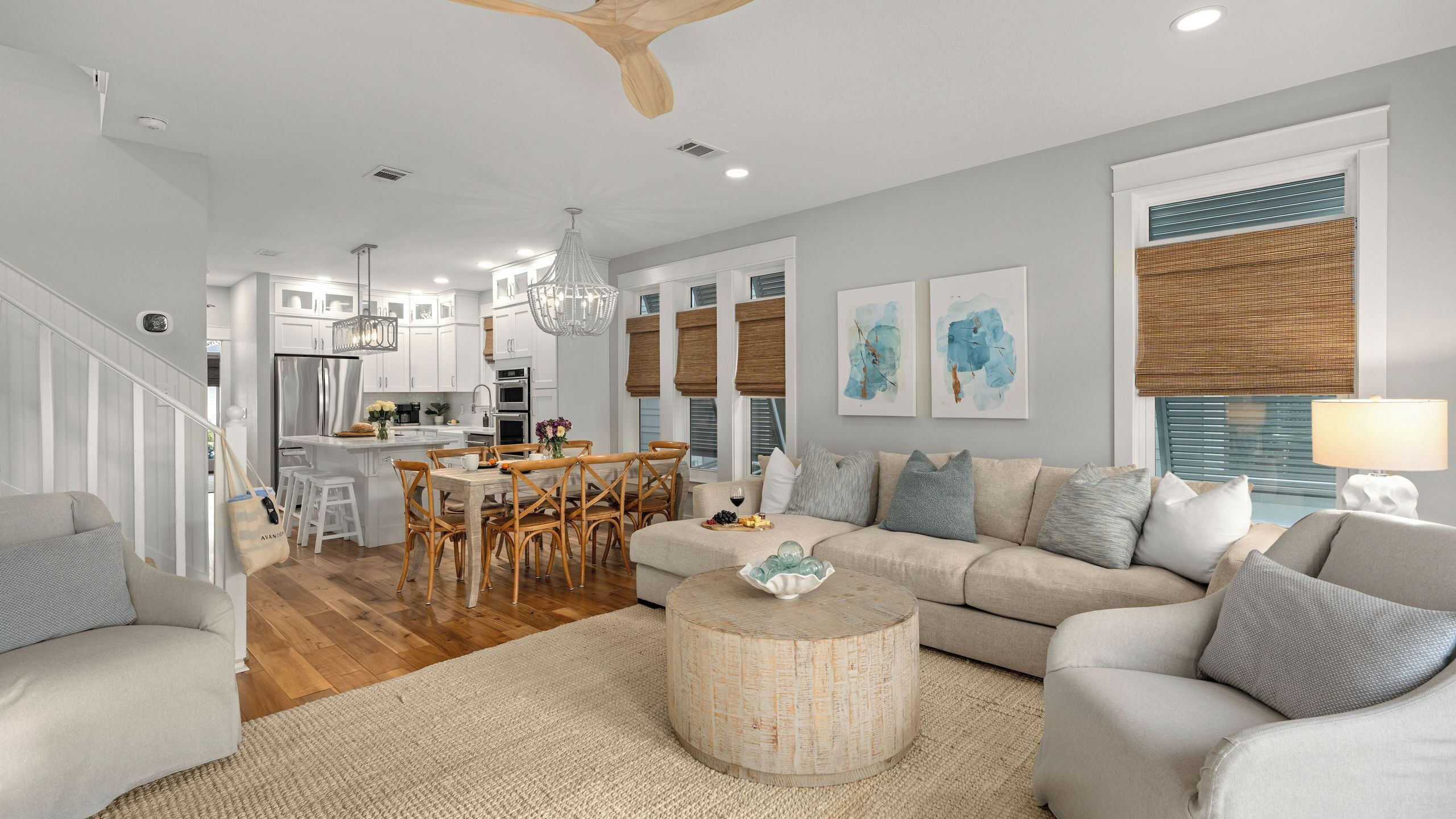 A modern living room with a sofa, coffee table, and dining area.