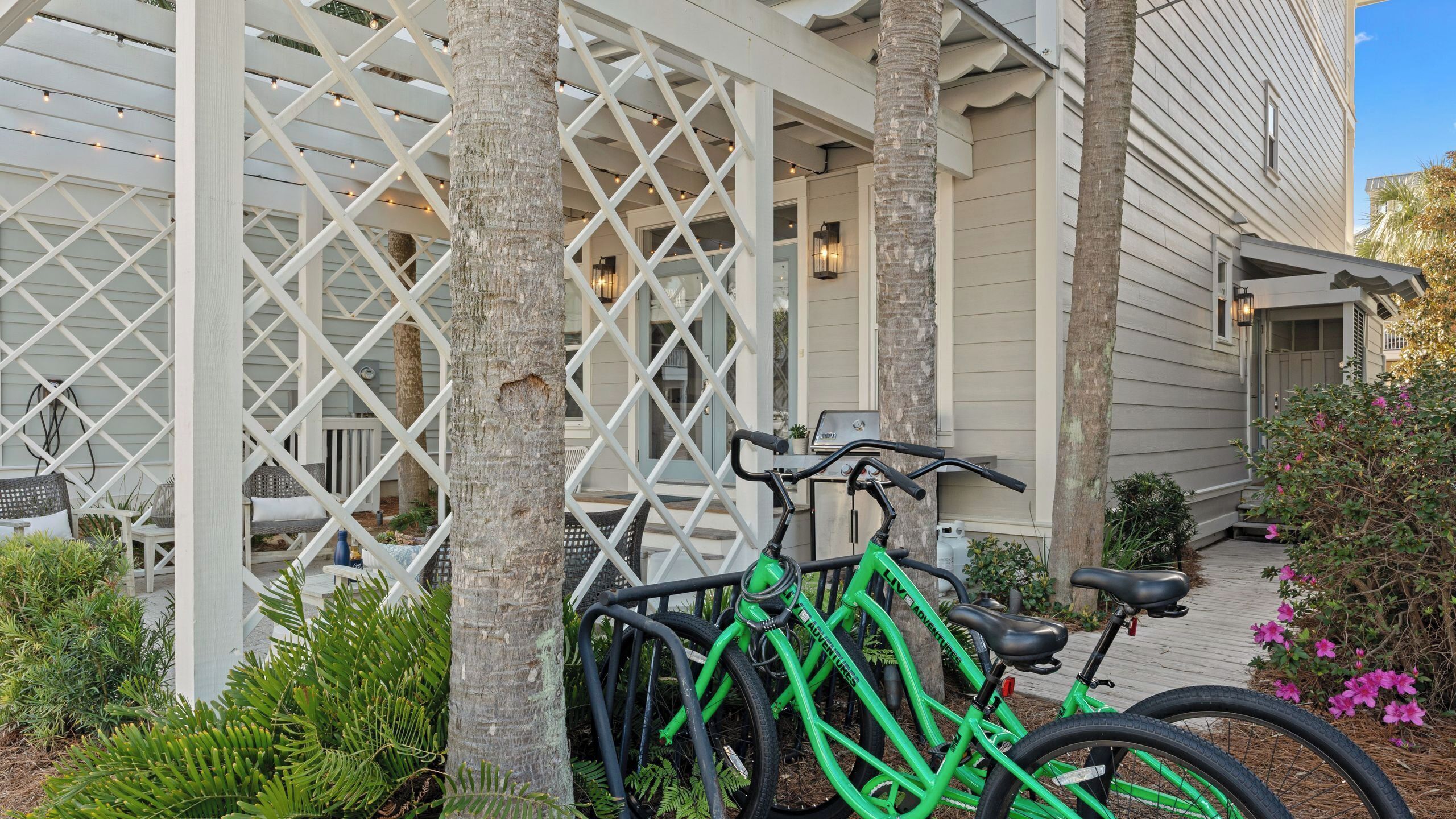 A bicycle parked in front of a building with a lattice structure.