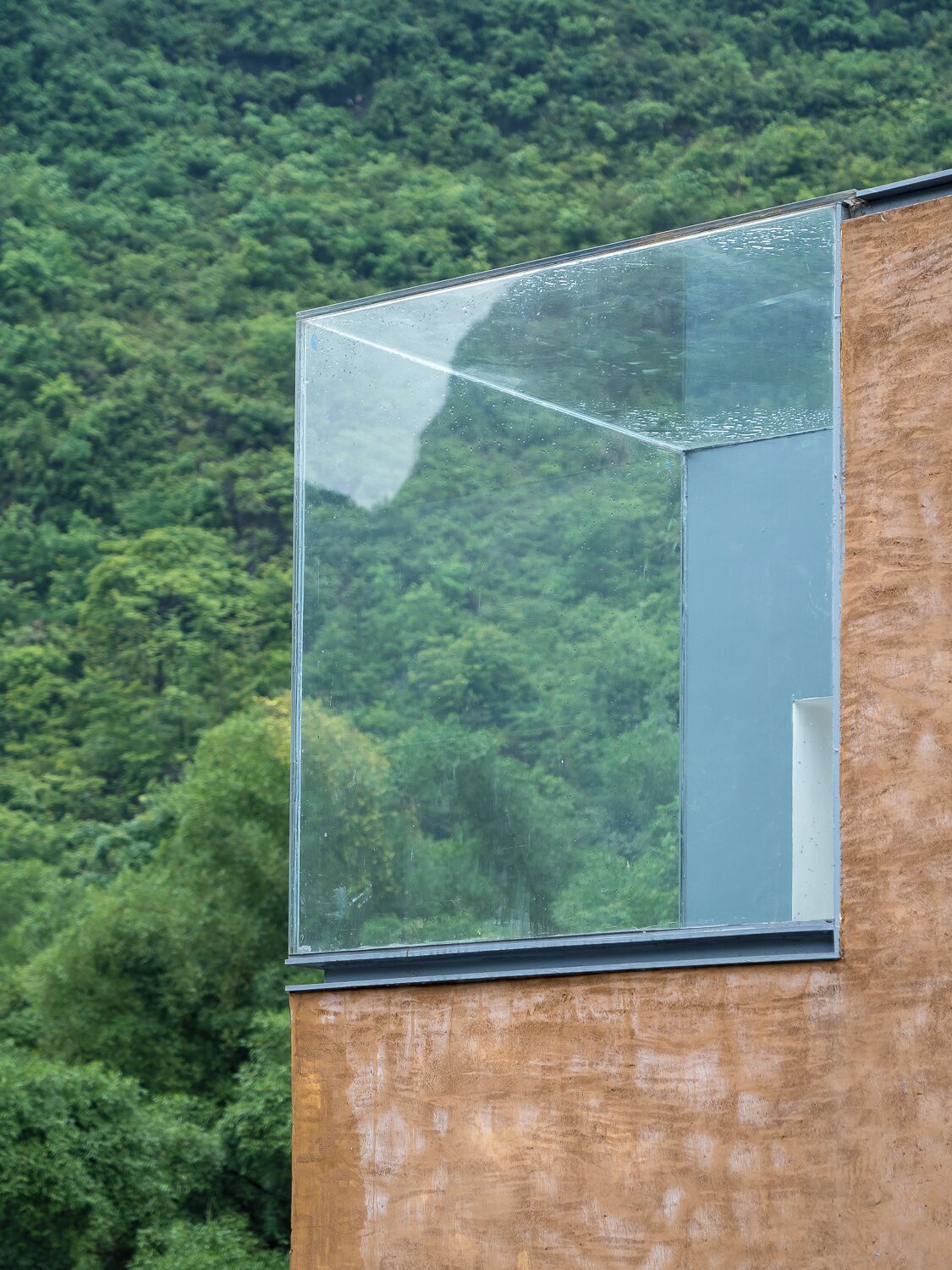 A modern building with a large glass window.