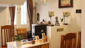 Una reception con una insegna, una ventola a soffitto e un dipinto religioso incorniciato.