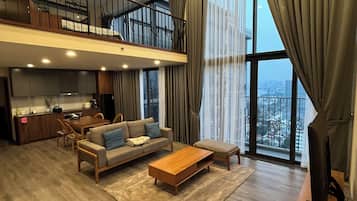 Deluxe Duplex, Balcony, City View | Living area | Flat-screen TV