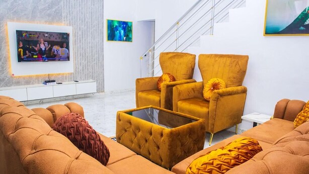 A modern living room with a sofa, armchairs, and a coffee table. - 4-Bedroom Duplex with Private Bathrooms in all Rooms (Lekki-Ajah Express Way)