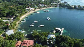 Enjoy boating and water activities in this scenic coastal area with lush greenery and a marina.
