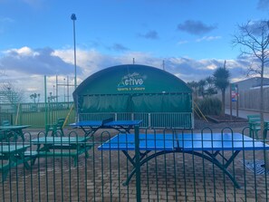 Enjoy a game of table tennis or relax at one of the picnic tables in this sports and leisure facility.