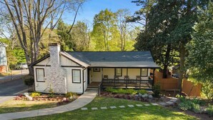 A single-story house with a stone chimney, a front porch, and a well-maintained lawn. - Marietta Square Suites - Suite3 - Cozy Studio! (Marietta)