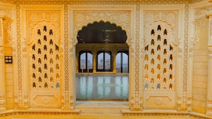 A room with intricate architectural details, including ornate doorways and a central arched window. - Hotel Durjay Garh (Jaisalmer)