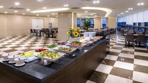 A buffet area with various food stations and seating arrangements.