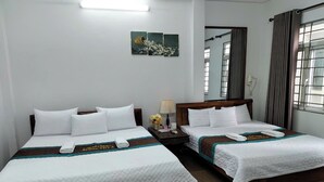 A hotel room with two beds, a nightstand, a lamp, and a painting on the wall. - Huong Villa Hotel HN - by BAY LUXURY (Hanoi)