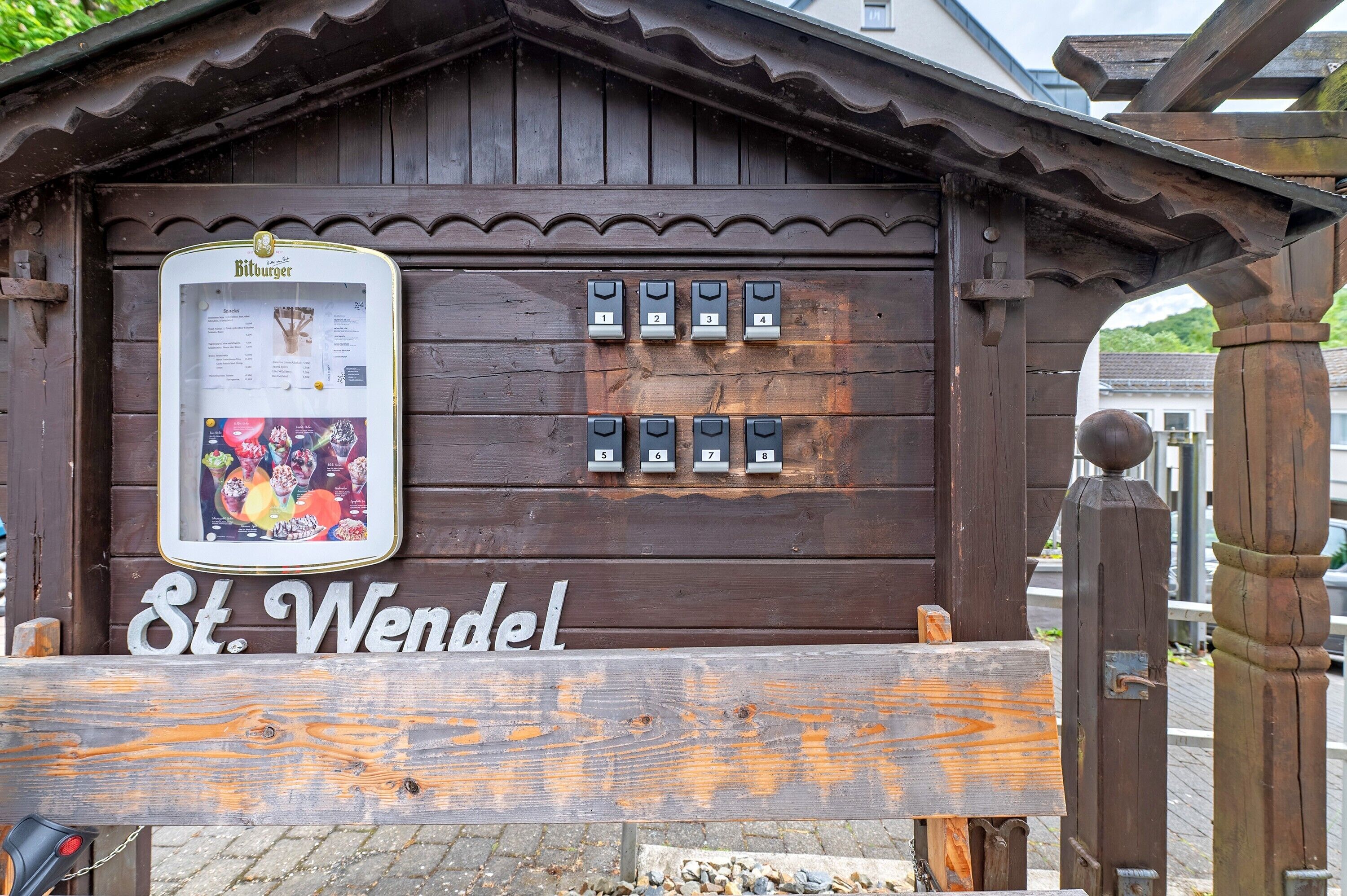 A wooden building with a sign reading 'St. Wendel' and numbered mailboxes.