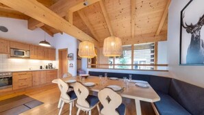 A modern kitchen with wooden cabinets and a microwave.
